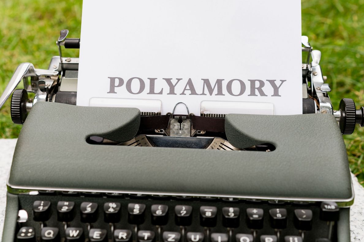 A typewriter with the word polyamory printed on the paper