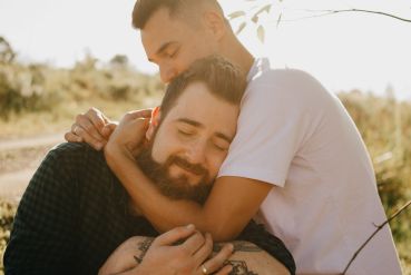 Two men hugging with their eyes closed