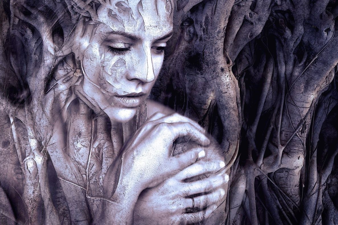 An artistic image of a woman blending with a tree